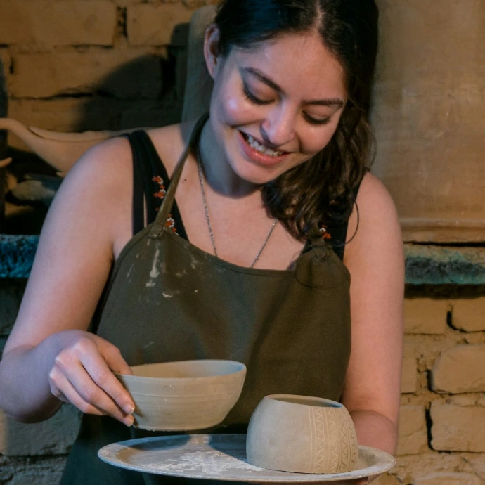 woman in black tank top holding white ceramic bowl